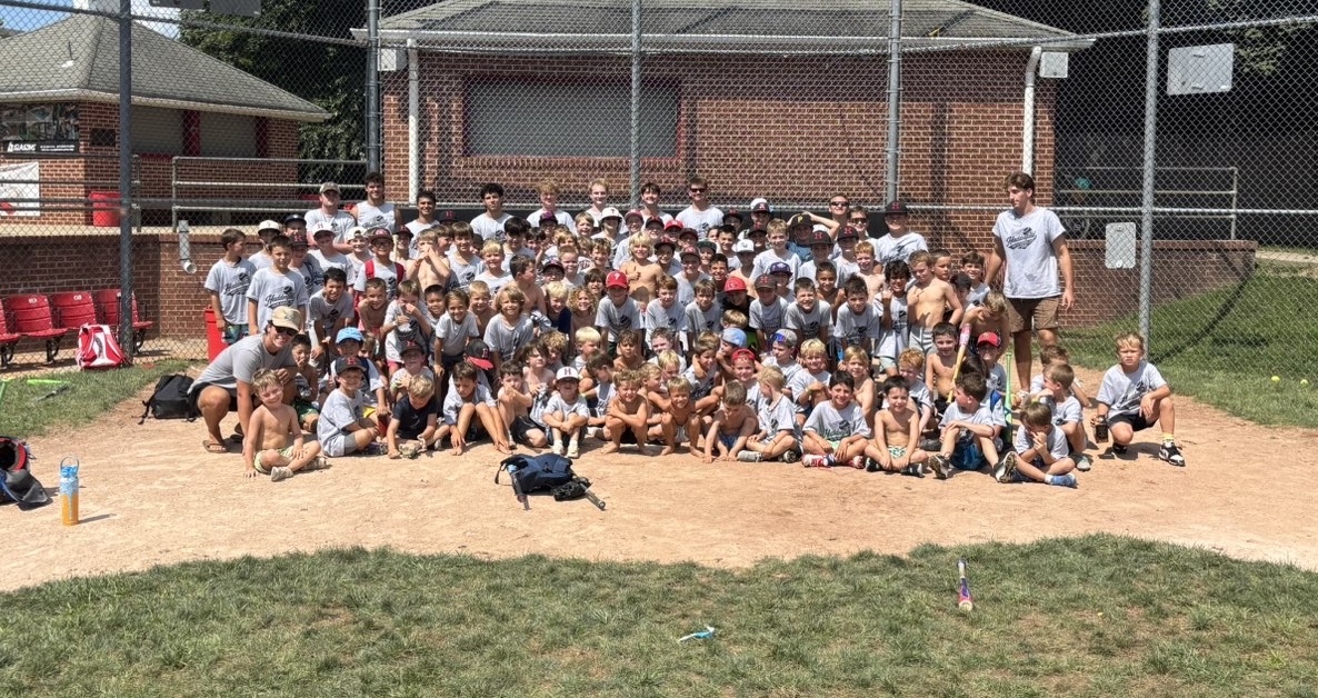 Full group photo of WIN campers and coaches on the field at Haddonfield Youth Baseball Camp