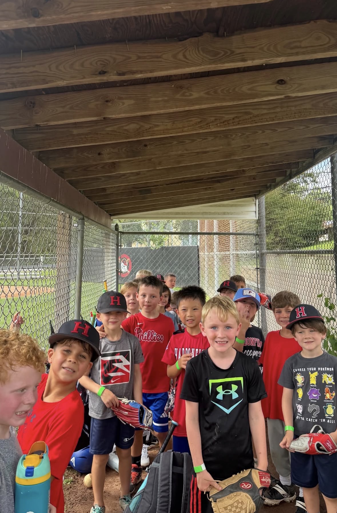 Campers lined up in the dugout before heading out to their stations