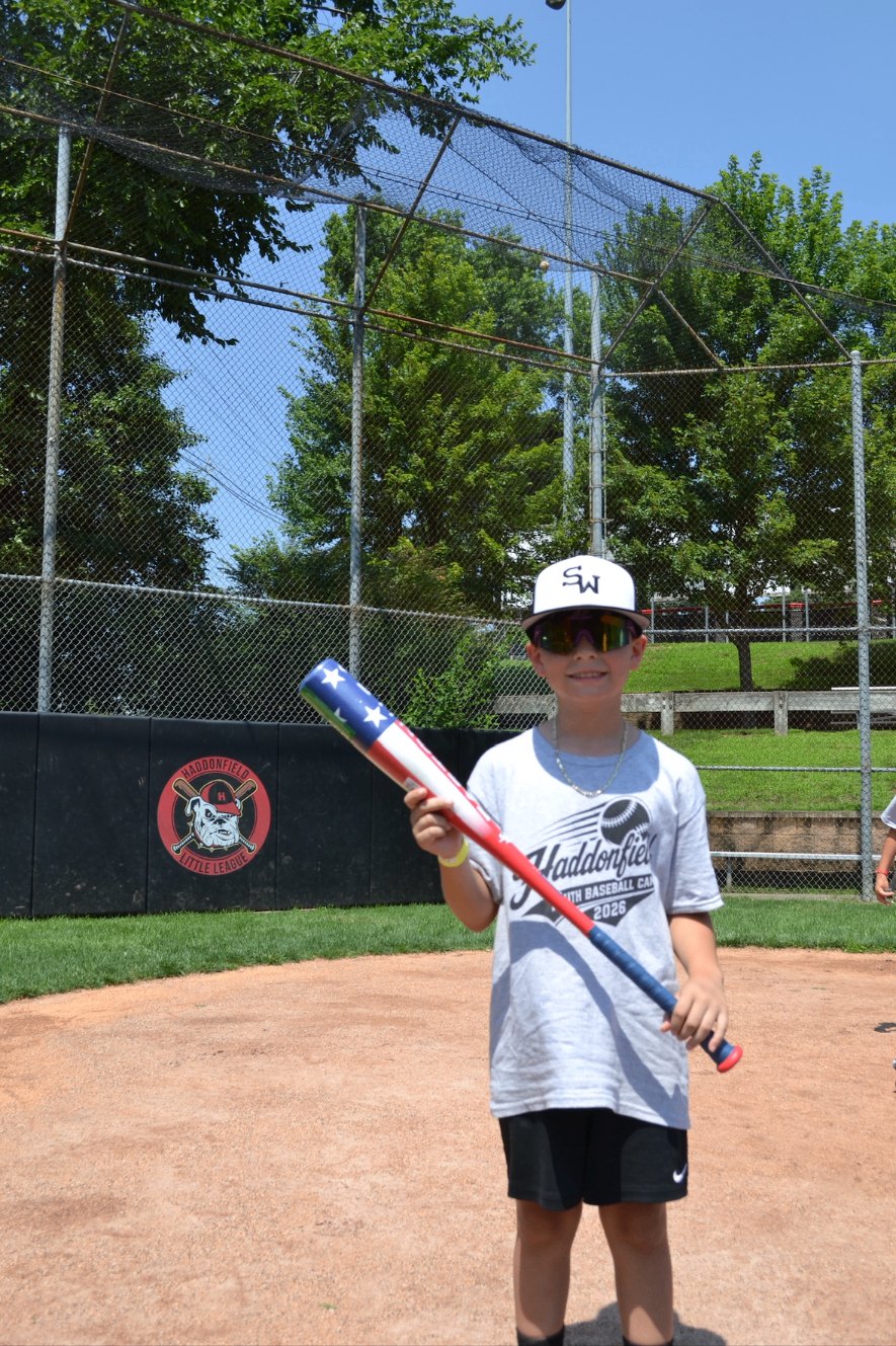 A young camper holding a bat at the Haddonfield Little League complex